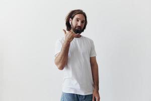 happy man listening to music and smiling in a white t-shirt on a white background happy photo