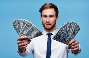 business man shirts wads of money wealth emotions blue background photo