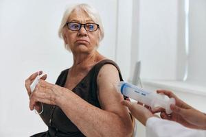 emotional elderly woman syringe injection vaccine passport photo