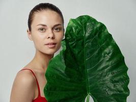 woman natural look green leaf palm tree clean skin photo