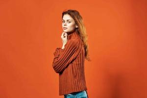woman in red sweater fashion studio posing red background photo