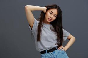 pretty woman in a t-shirt and jeans posing Youth style studio model photo