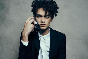 photographer with camera indoors on gray background and jacket curls shirt model photo