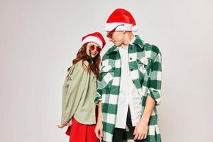 Man and woman in Christmas hats with sunglasses studio fashion holiday photo