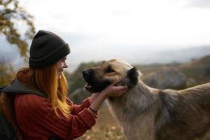 woman playing with dog outdoors travel friendship together photo