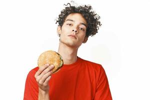 curly-haired guy fast food in the hands of a snack food diet light background photo