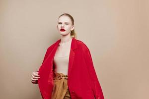 portrait of a woman makeup in red jacket isolated background photo