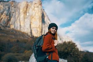 Cheerful woman tourists mountains nature clouds travel photo