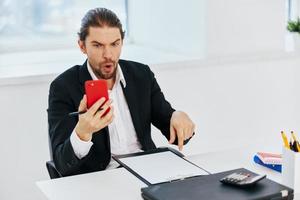 Man at the desk documents communication by phone technology photo