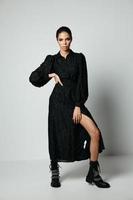 pretty brunette in black dress posing boots fashion photo