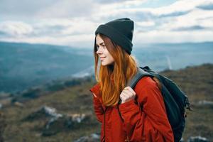 woman jacket hats looking at the mountain in the distance blue sky clouds Model backpack photo