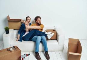 young couple in the room housewarming boxes with things moving emotions fun photo