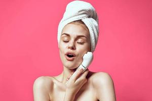 woman with towel on head naked shoulders facial massage photo