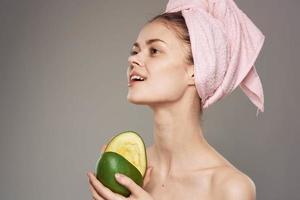 woman with bare shoulders clean health mango skin in hands of spa procedure photo