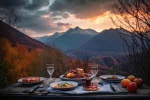 Romantic dinner with view of mountain at sunset. photo