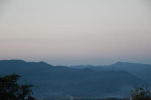 sunrise sunset sky with clouds over the mountain view background photo