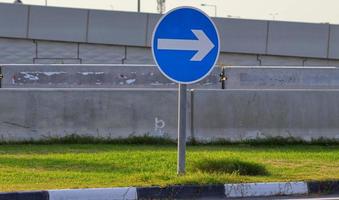 Road sign arrow pointing to the right ,blue road sign with white arrow photo