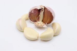 Peeled or un peeled fresh garlic on white background,bulb garlic clove photo
