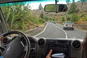 white off-road cars traveling on the roads around the Teide volcano on the Spanish Canary Island of Tenerife for a trip photo