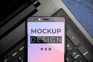 Smartphone Screen Mockup over a notebook keyboard copy space. Modern mobile Top view. psd