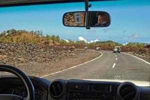white off-road cars traveling on the roads around the Teide volcano on the Spanish Canary Island of Tenerife for a trip photo