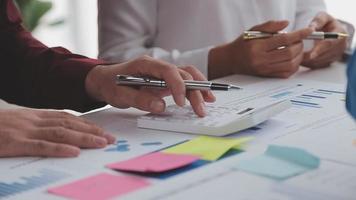 Financial analysts analyze business financial reports on a digital tablet planning investment project during a discussion at a meeting of corporate showing the results of their successful teamwork. video