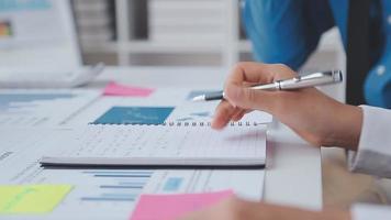 Financial analysts analyze business financial reports on a digital tablet planning investment project during a discussion at a meeting of corporate showing the results of their successful teamwork. video