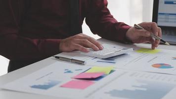 Financial analysts analyze business financial reports on a digital tablet planning investment project during a discussion at a meeting of corporate showing the results of their successful teamwork. video