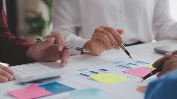 Financial analysts analyze business financial reports on a digital tablet planning investment project during a discussion at a meeting of corporate showing the results of their successful teamwork. video