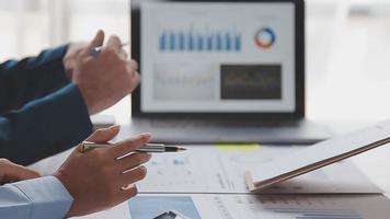 Financial analysts analyze business financial reports on a digital tablet planning investment project during a discussion at a meeting of corporate showing the results of their successful teamwork. video