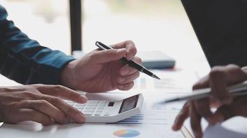 Financial analysts analyze business financial reports on a digital tablet planning investment project during a discussion at a meeting of corporate showing the results of their successful teamwork. video