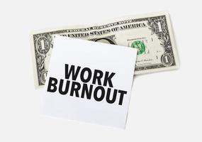 1 dollar bill and white notepad sheet on the white background. Text work burnout photo