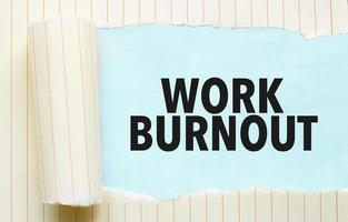 torn paper with text work burnout and blue background photo