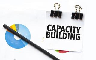 capacity building on notebook with charts and pencil photo