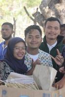 Atambua, Nusa Tenggara Timur, 2022 Smiling tourists who are being standing waiting in line to eat photo