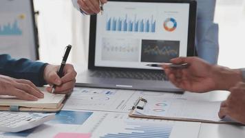Financial analysts analyze business financial reports on a digital tablet planning investment project during a discussion at a meeting of corporate showing the results of their successful teamwork. video