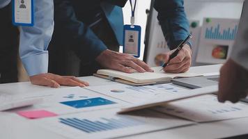 Financial analysts analyze business financial reports on a digital tablet planning investment project during a discussion at a meeting of corporate showing the results of their successful teamwork. video