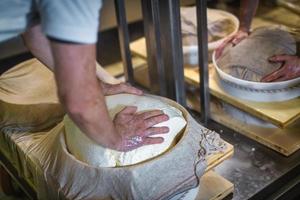 Cheese wheel preparation in a dairy photo