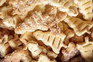 tasty background of cinnamon cakes from puff pastry in the shape of a Christmas tree in close-up photo