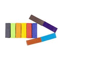 Kids multicolored plasticine folded in the shape of an arrow. Kindergarten. White background photo