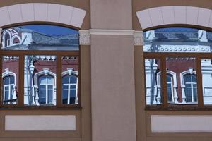 Windows that reflect the facade of an old building. Background. photo