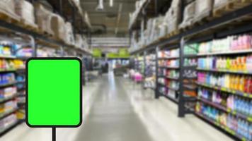 Blurred background Supermarket and green sign. Business background. Copy space. photo