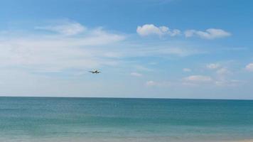 PHUKET, THAILAND NOVEMBER 27, 2019 - Plane of airline SCOOT lands at the international airport of Phuket, Thailand HKT. Landing plane from the sea over the heads of tourists, bright blue cloudy sky video