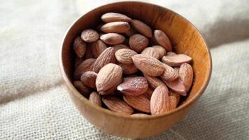 Close up of almond in a bowl isolated on white video