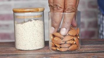 almond powder and almond in a jar on table video
