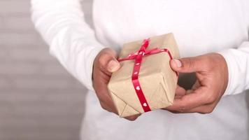 close up of man's hand holding a gift box with copy space video