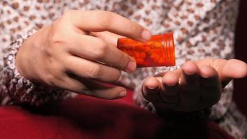 Man hand taking pills from pill container video