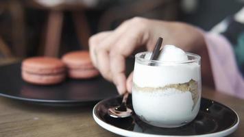 woman hand eating a jar of cheese cakes parfait video