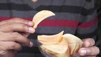 hand pick the potato chips from a bowl video