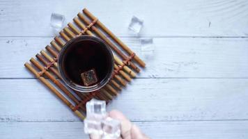 soft drinks in a glass with ice cube on white video